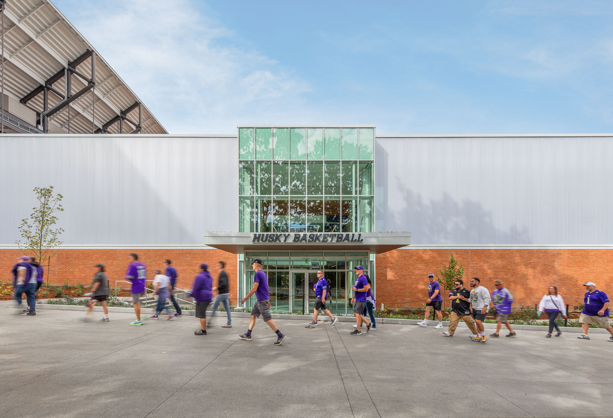 A group of people running outside of a building.