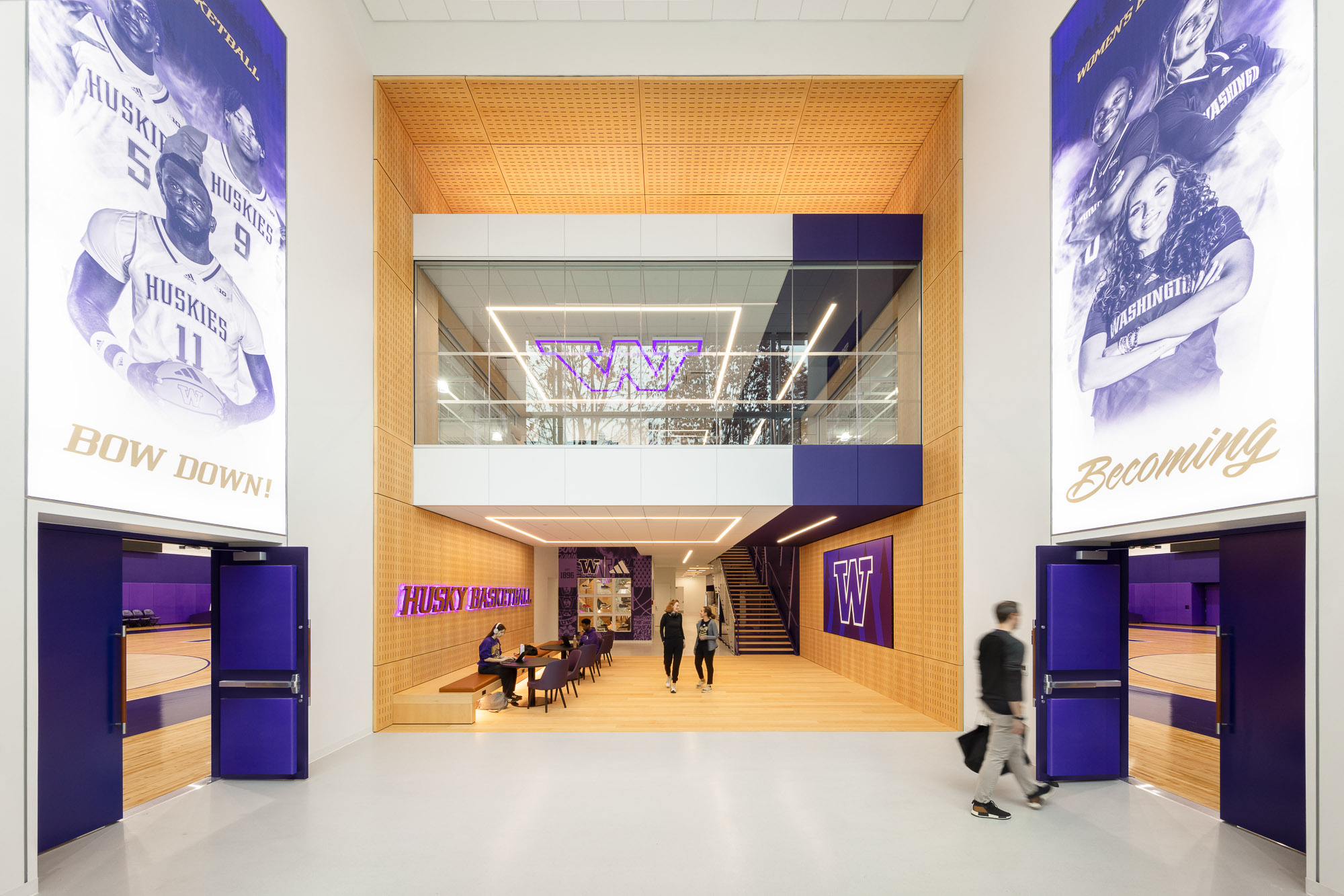 A group of people walking through a building.