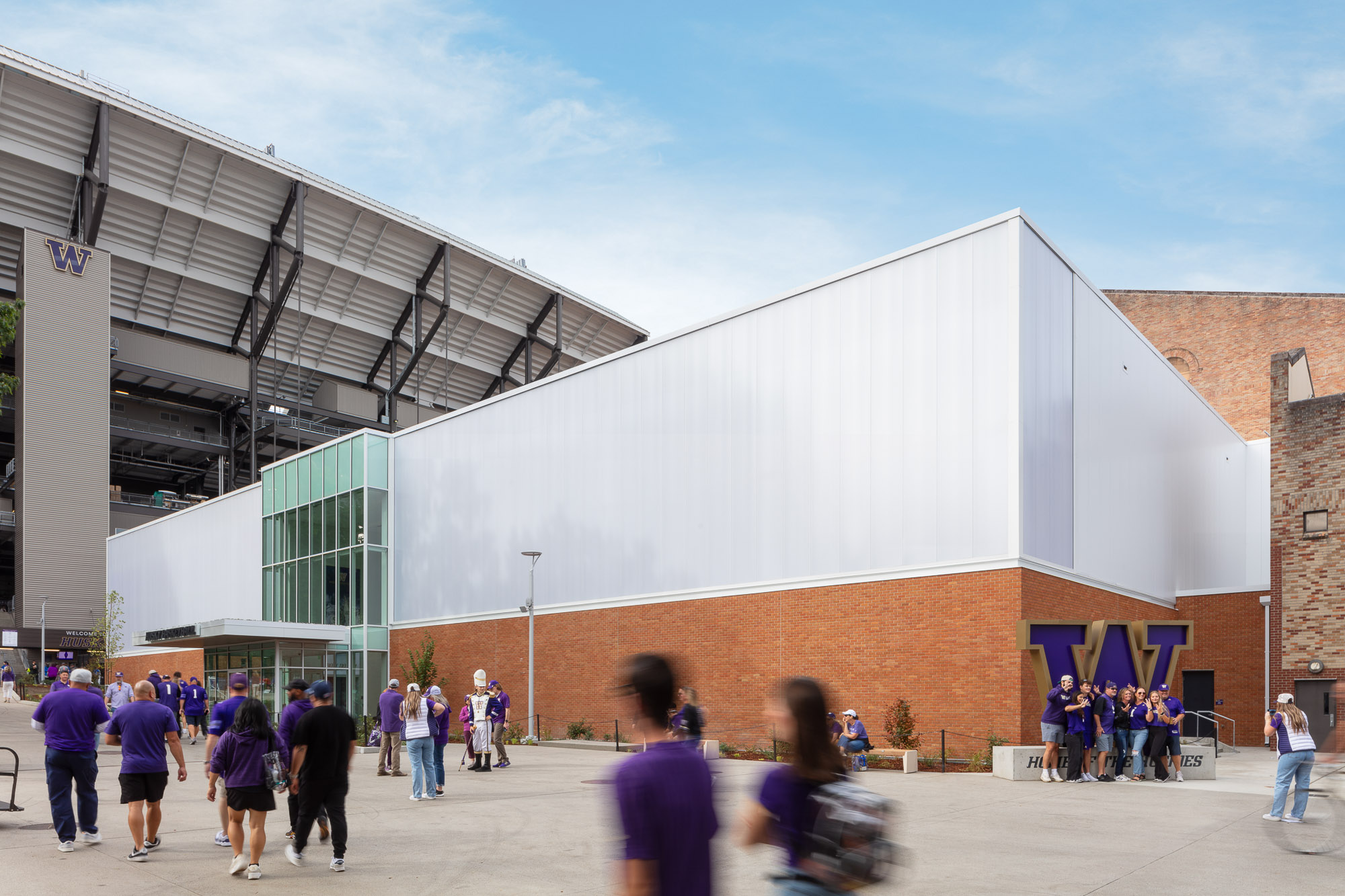 A group of people walking outside of a building.