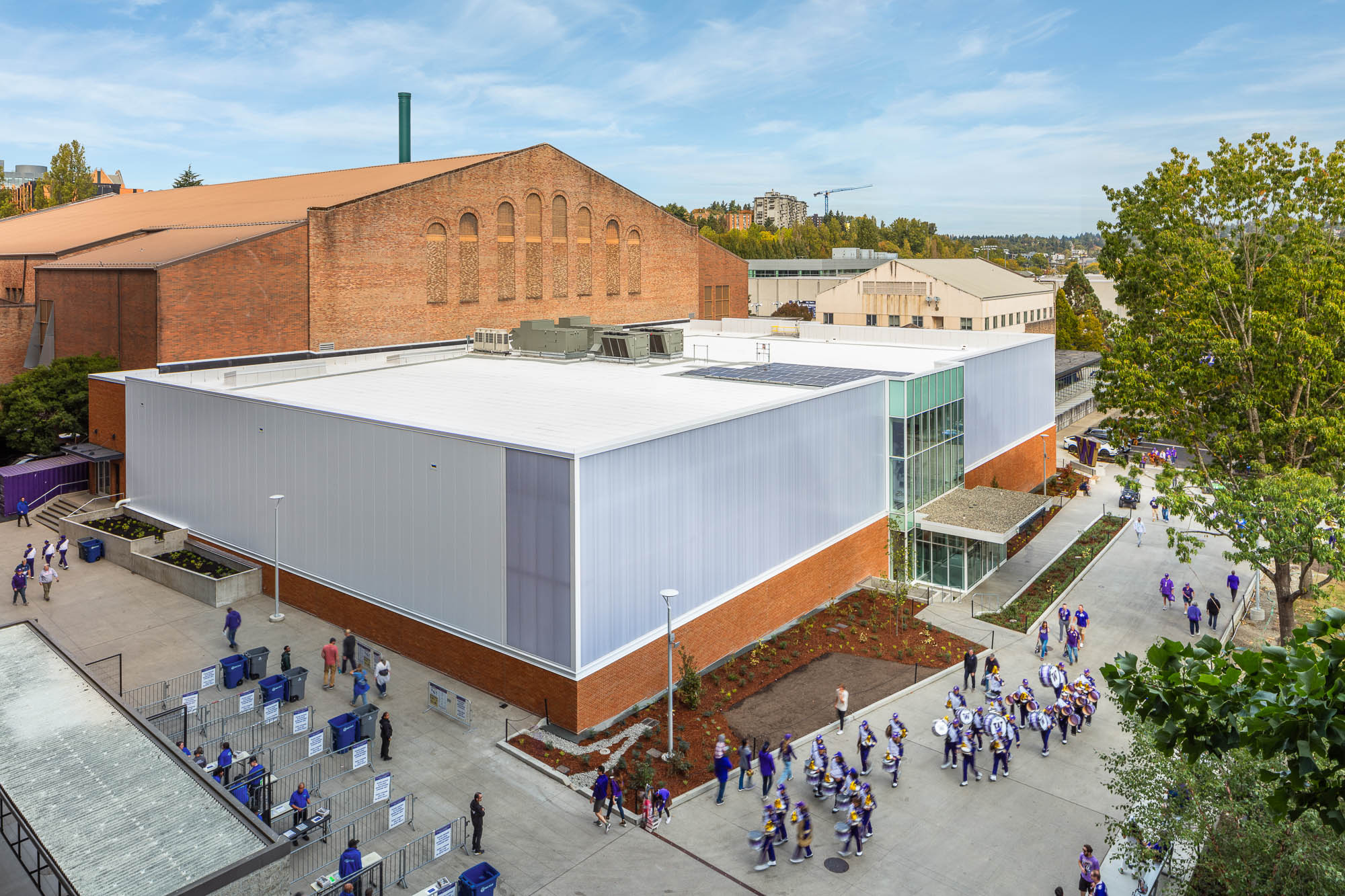 A large building with a large group of people walking around.