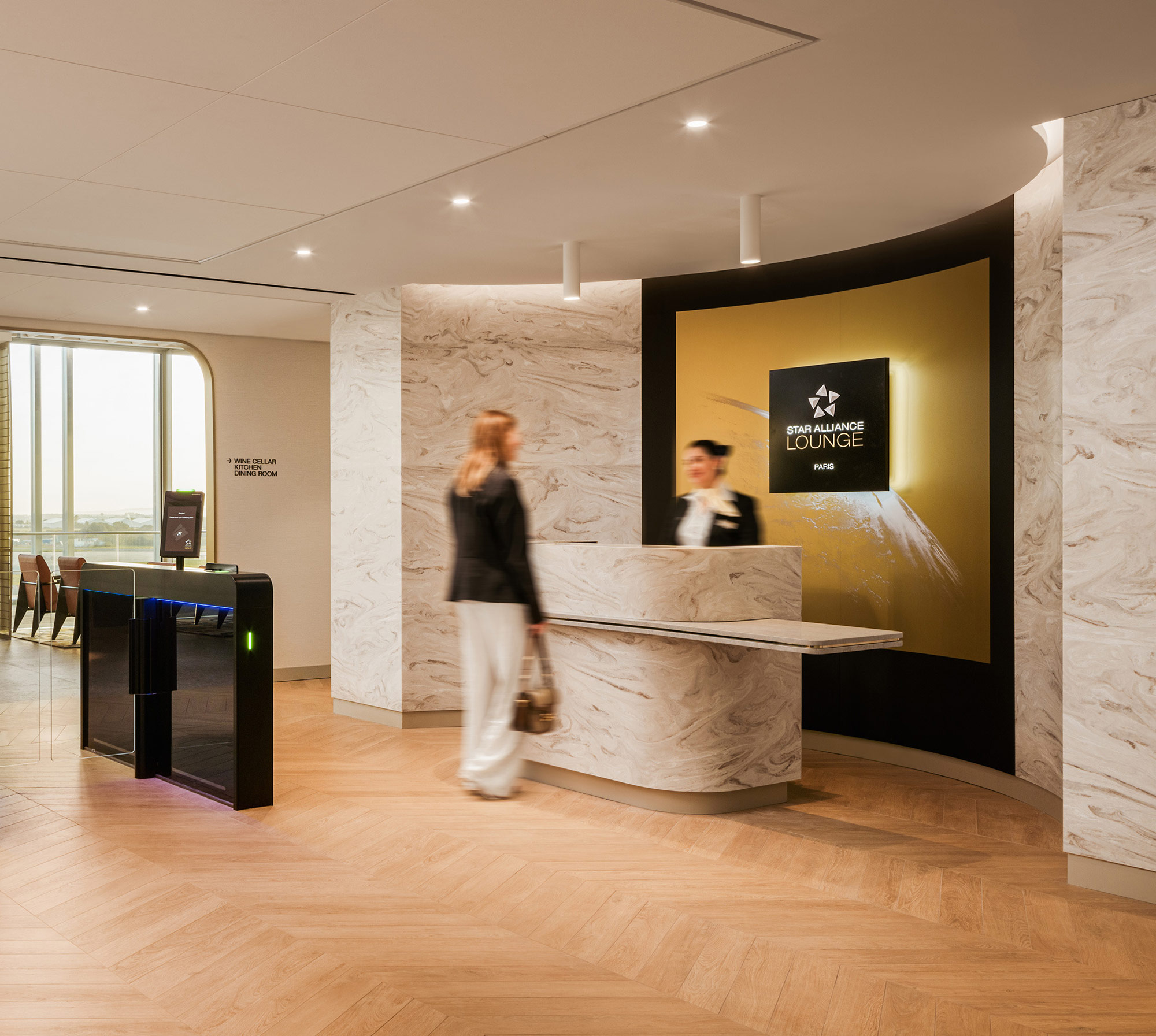 A man and woman standing next to a large sculpture.