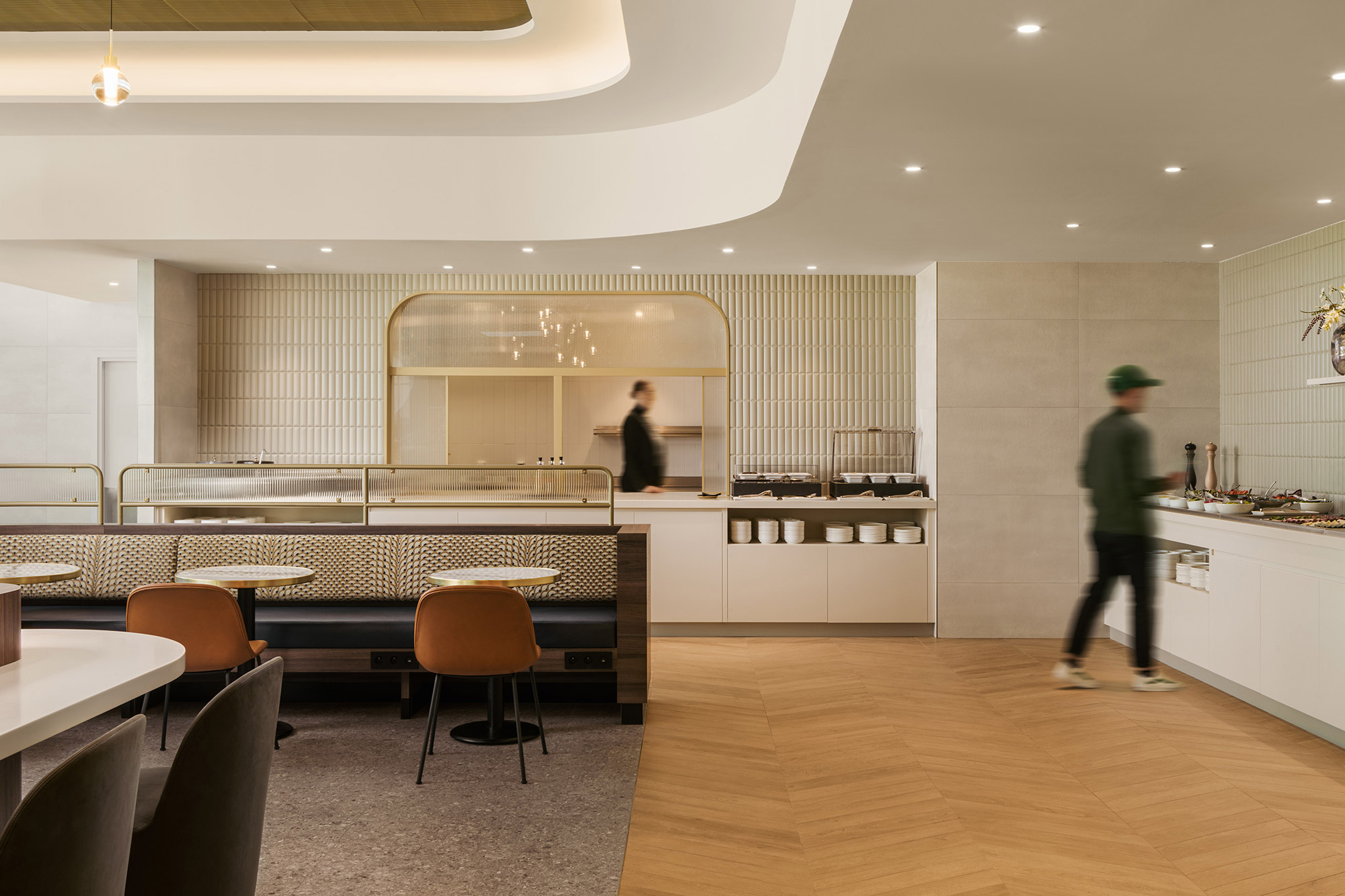 A couple of people in a kitchen.