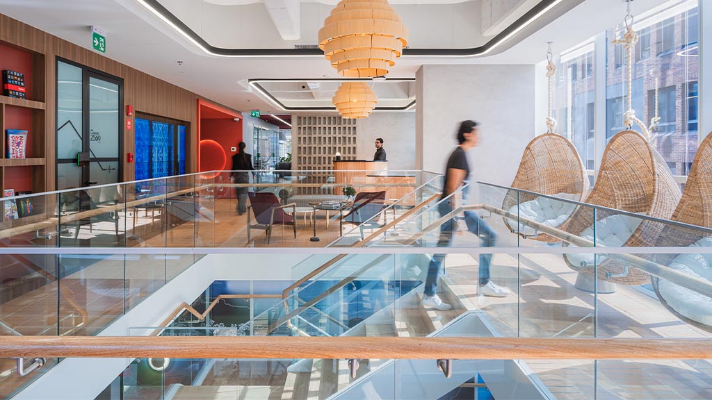 A group of people walking through a building.