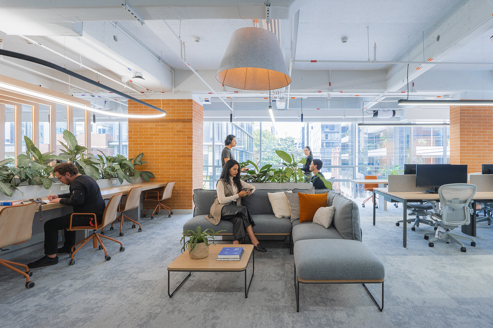 A group of people sitting in a room with tables and chairs.