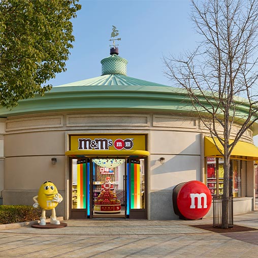 A store front with a green roof.