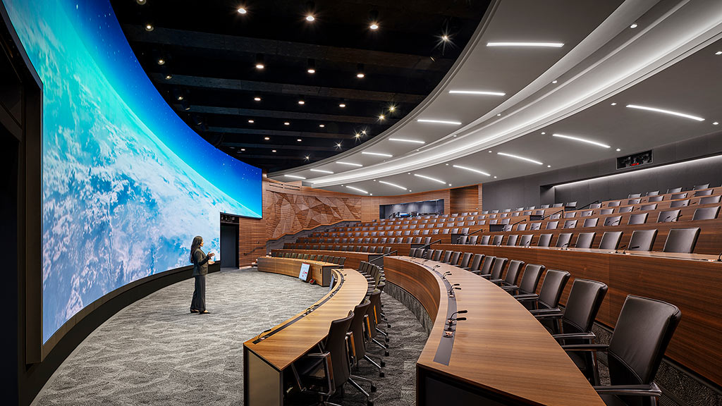 A person standing in a conference room.