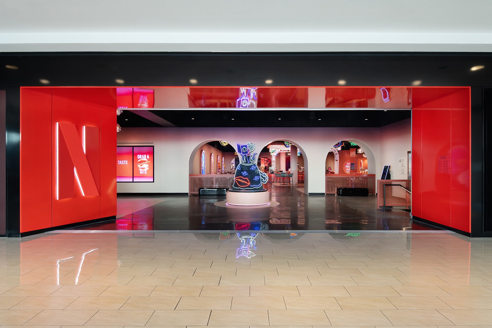 A large room with red walls and a large red and white sign.