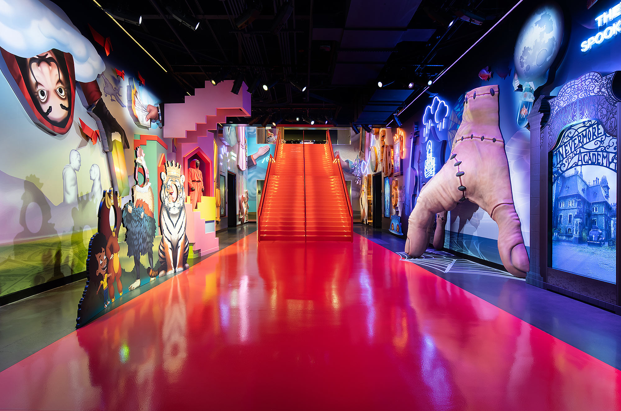 A person in a garment in a room with colorful walls.