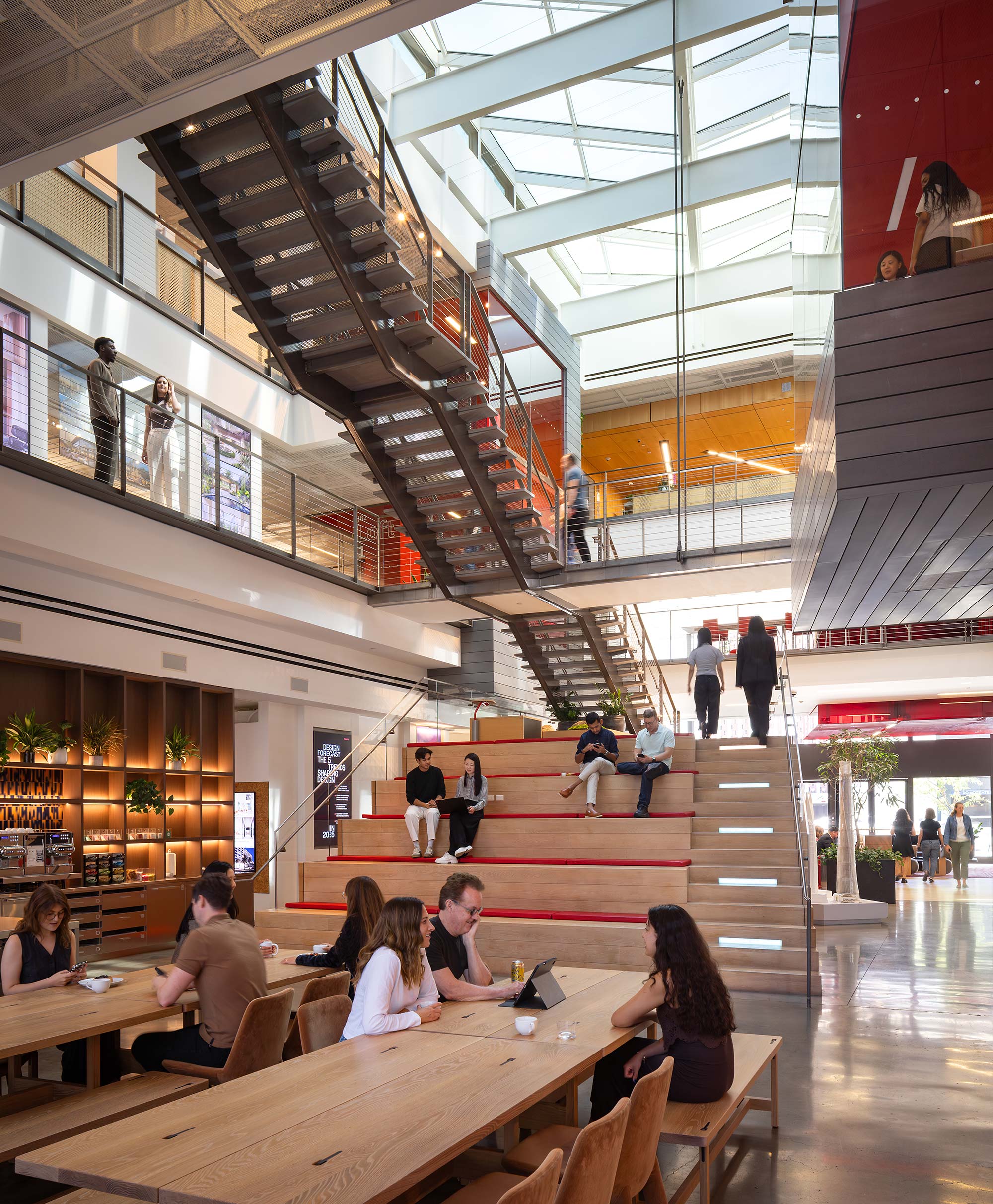 People sitting at tables in a large building.