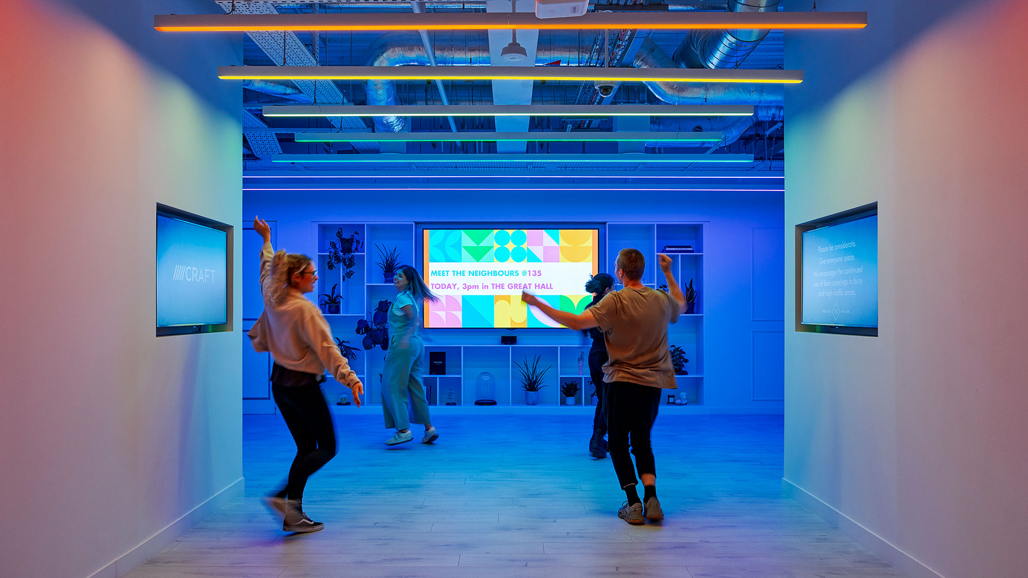 People in a room with a screen.