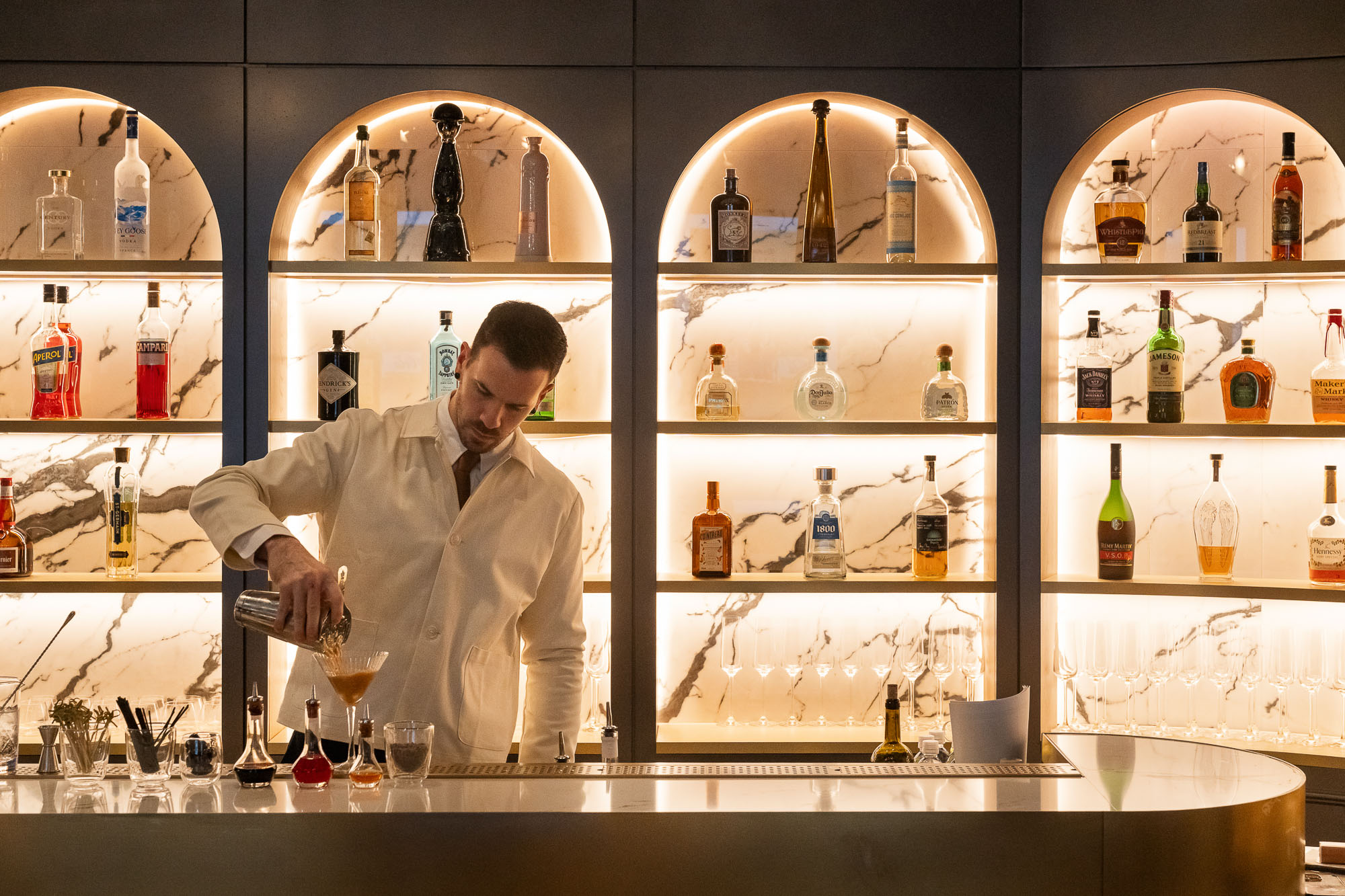 A man pouring wine into a glass.