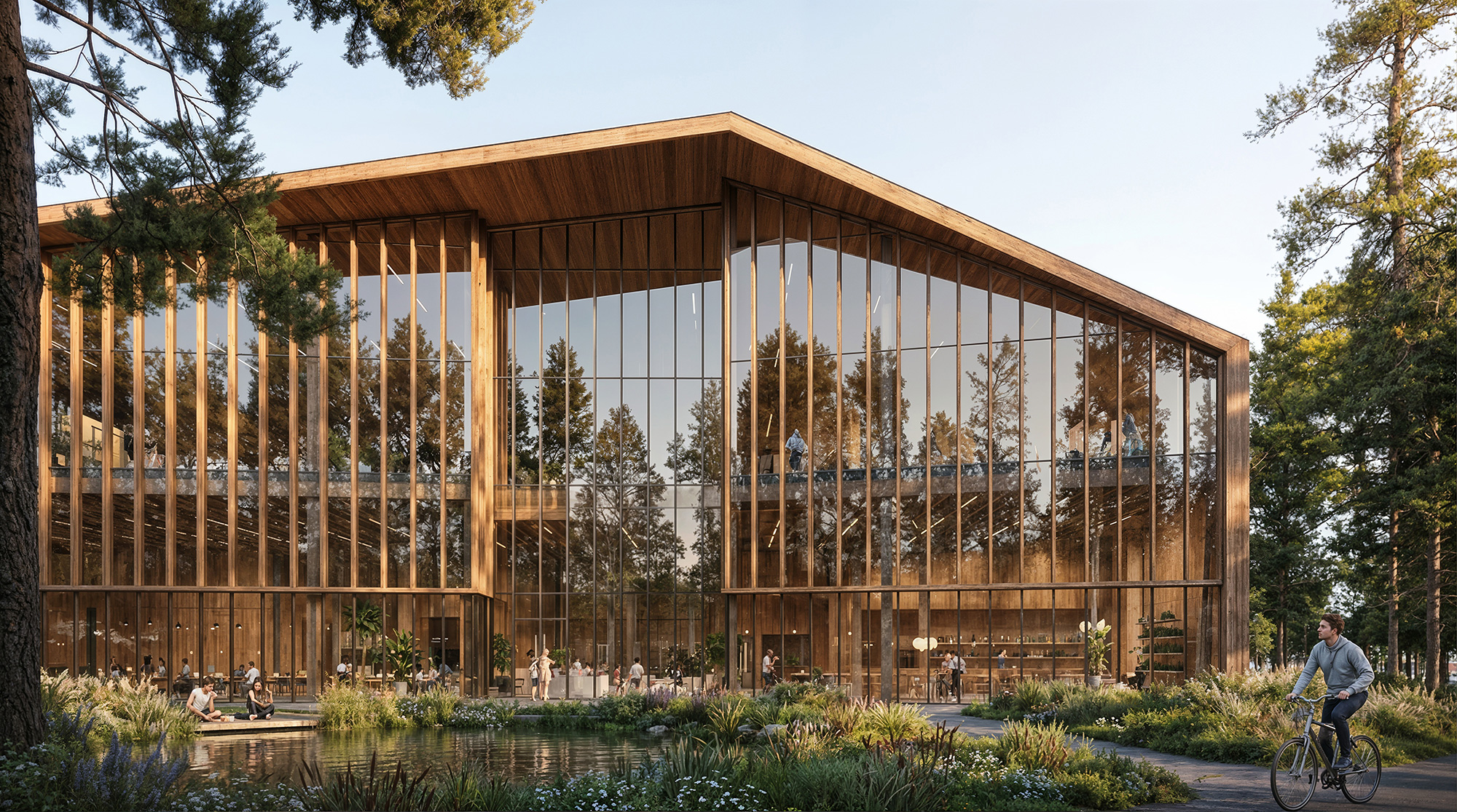 A person riding a bicycle in front of a glass building.