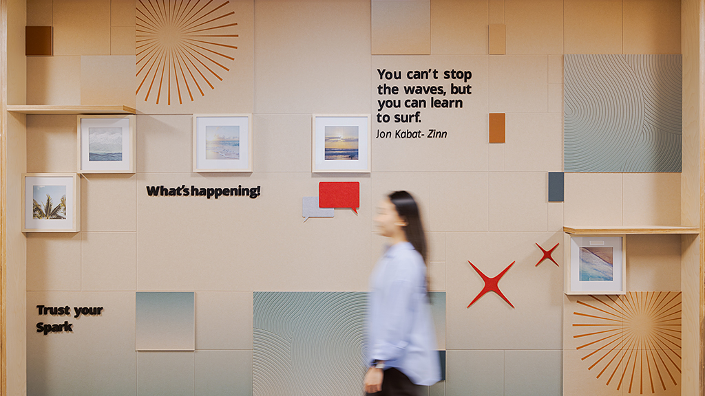 A person looking at a wall with pictures on it.