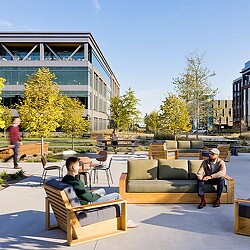 A group of people sitting on benches.