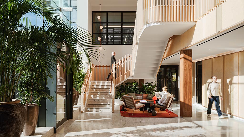 A few people walking down a hall.