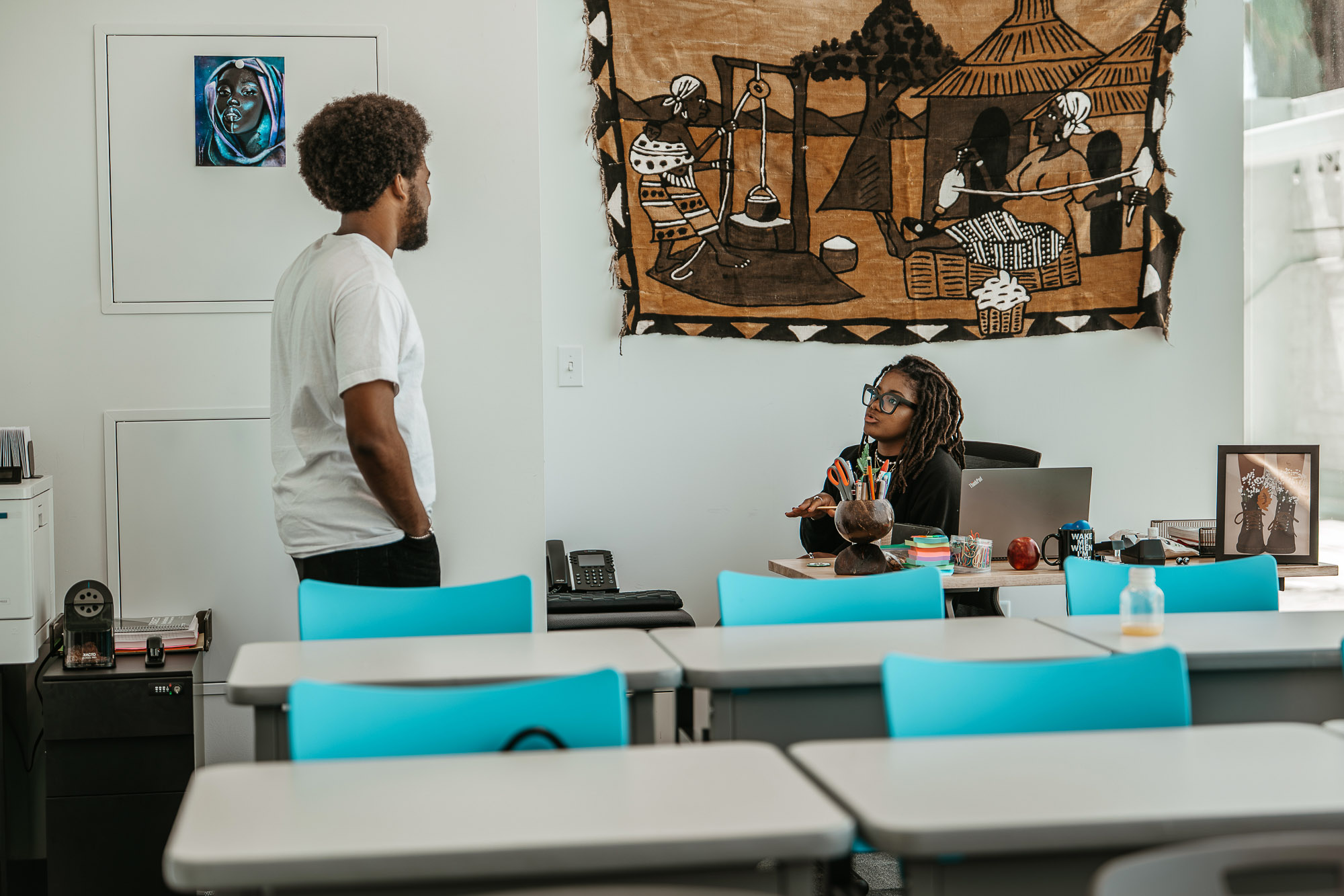 A man and a woman in an office.