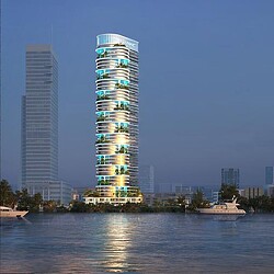 A couple of tall buildings by water.