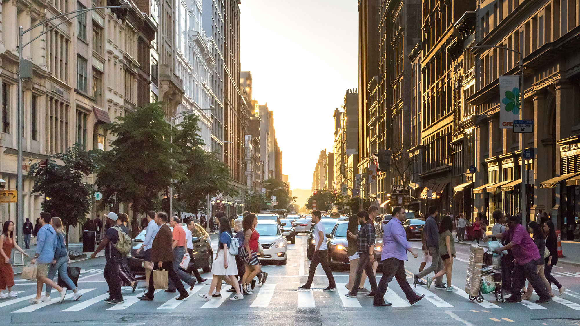 A group of people crossing a street.