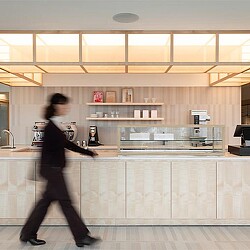 A person walking in a kitchen.