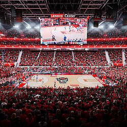 A basketball court with a crowd watching.