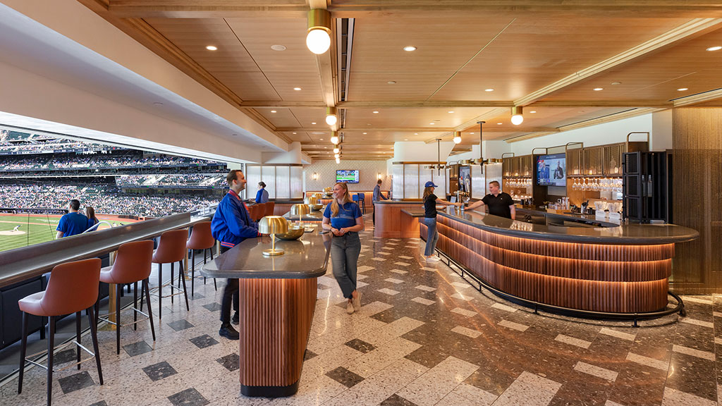 A group of people sitting at a table in a large room.