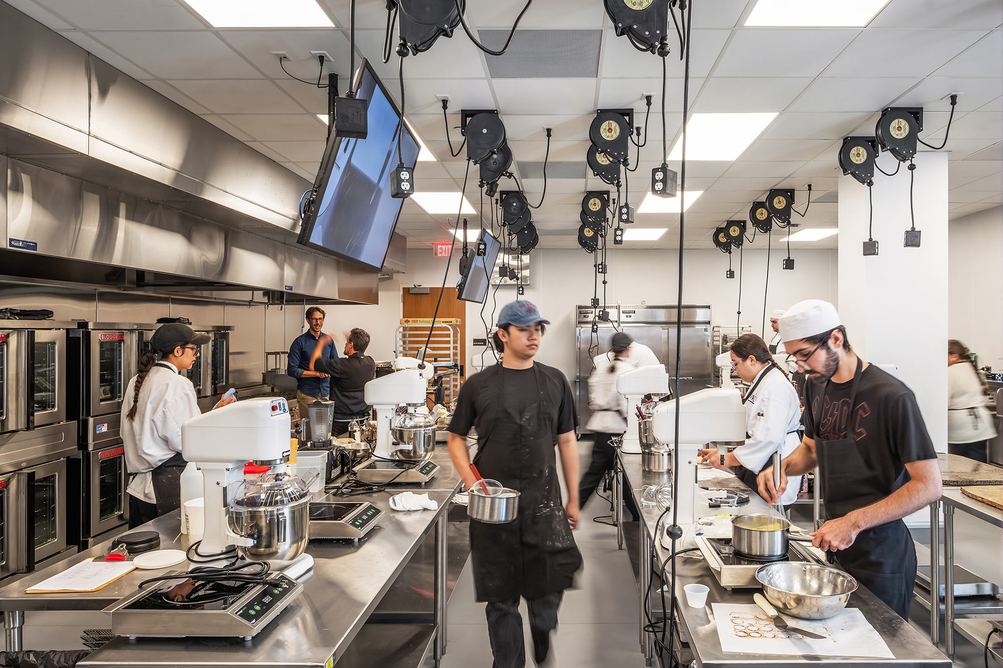 A group of chefs in a kitchen.