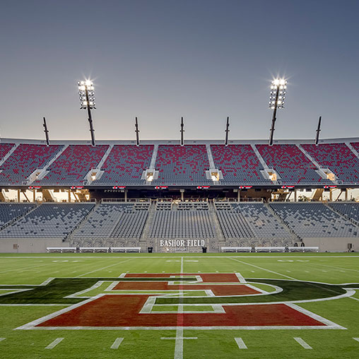 A football stadium with a field and a field with a crowd of people.