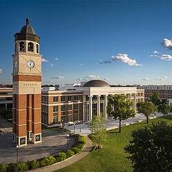 A clock tower in front of a building.