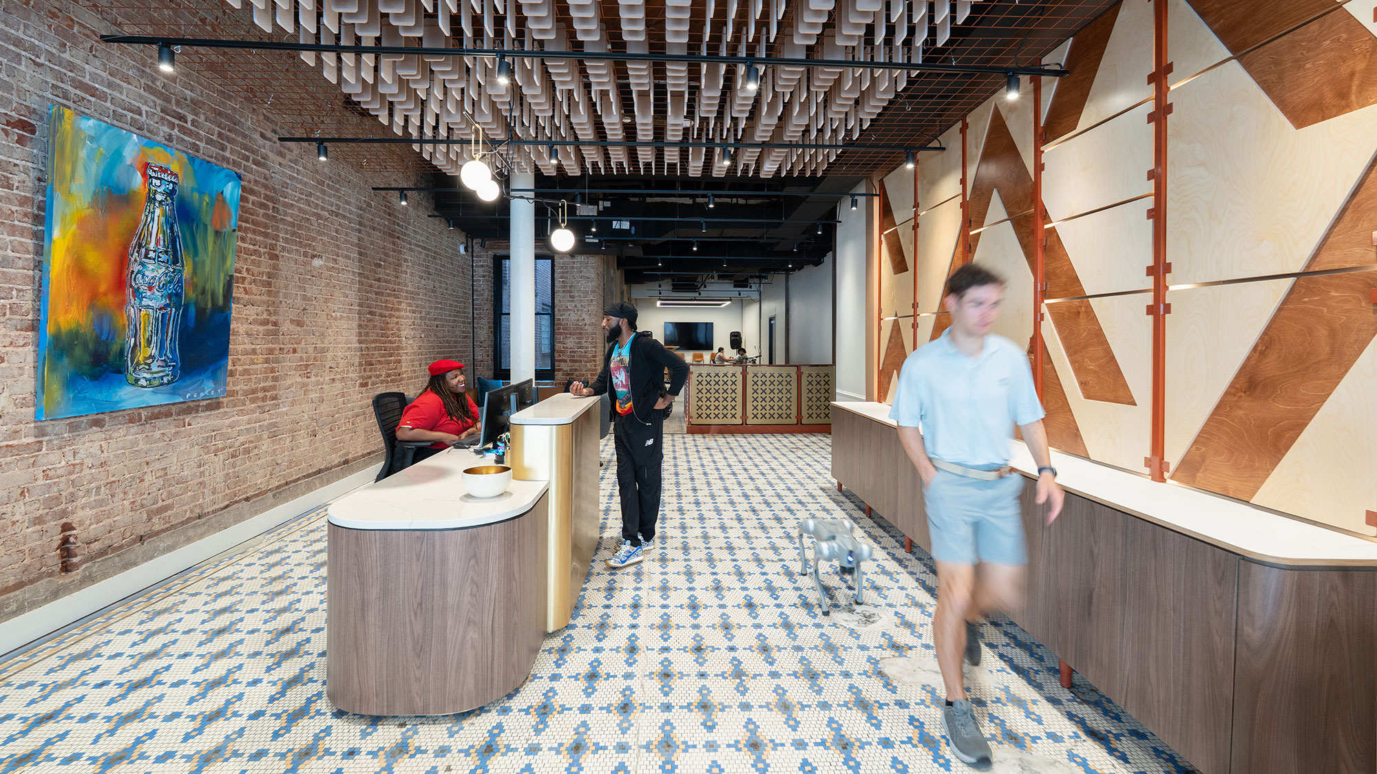A man standing in a room with a table and chairs.