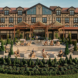 A group of people sitting outside a building.