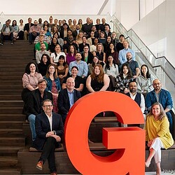 A group of people sitting on stairs.
