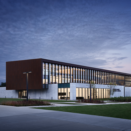 A building with a green lawn.