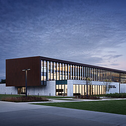 A building with a green lawn.
