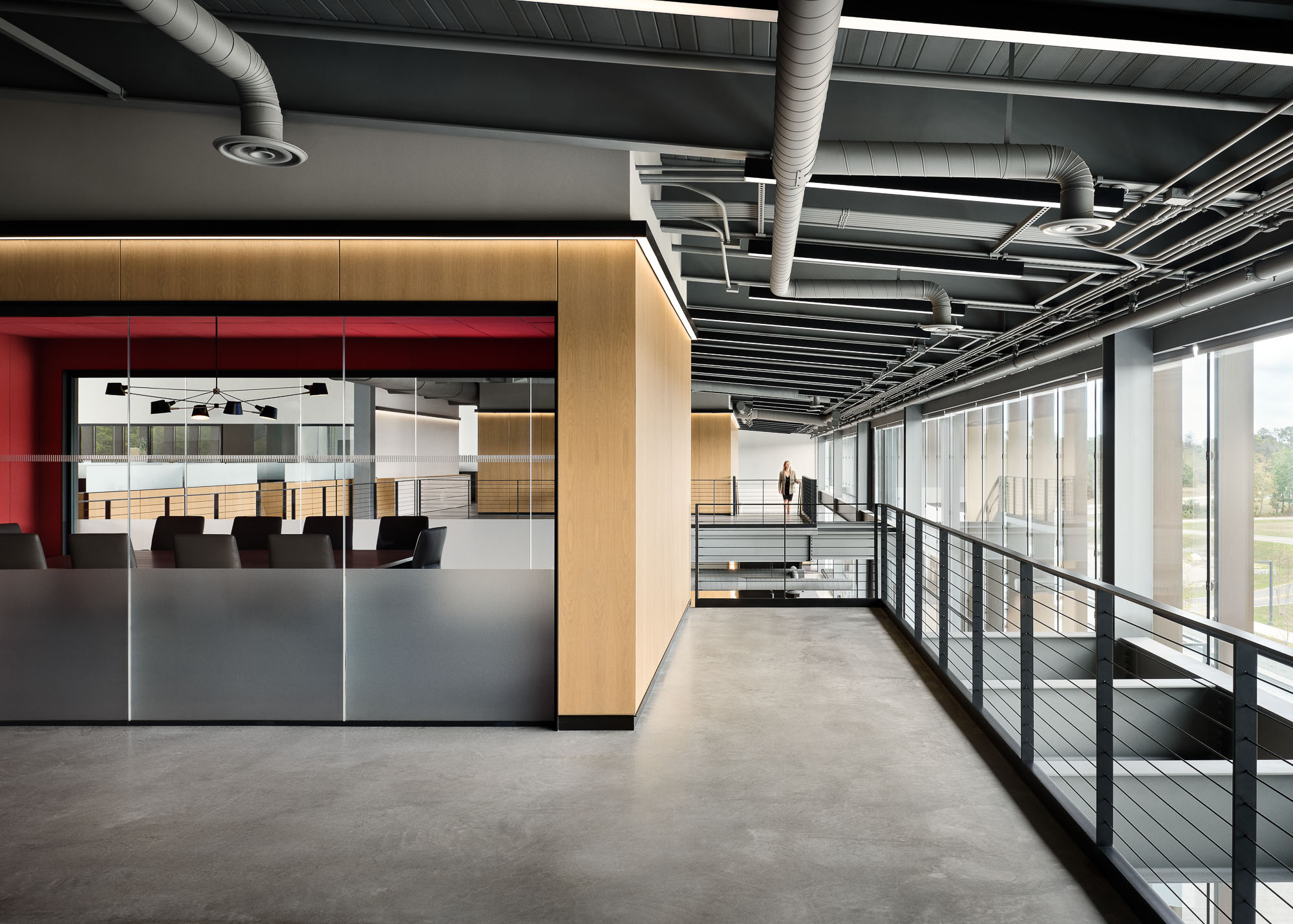 A large room with a few people.