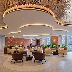 A room with a large ceiling and chairs.