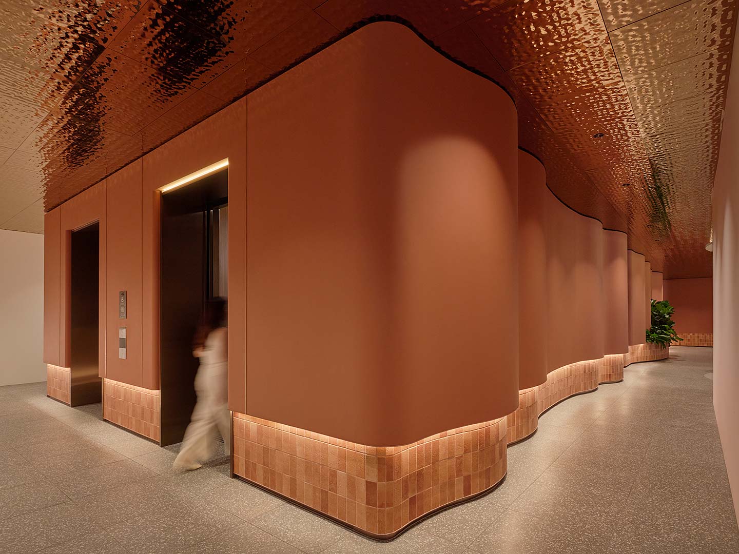 A person walking through a hallway.