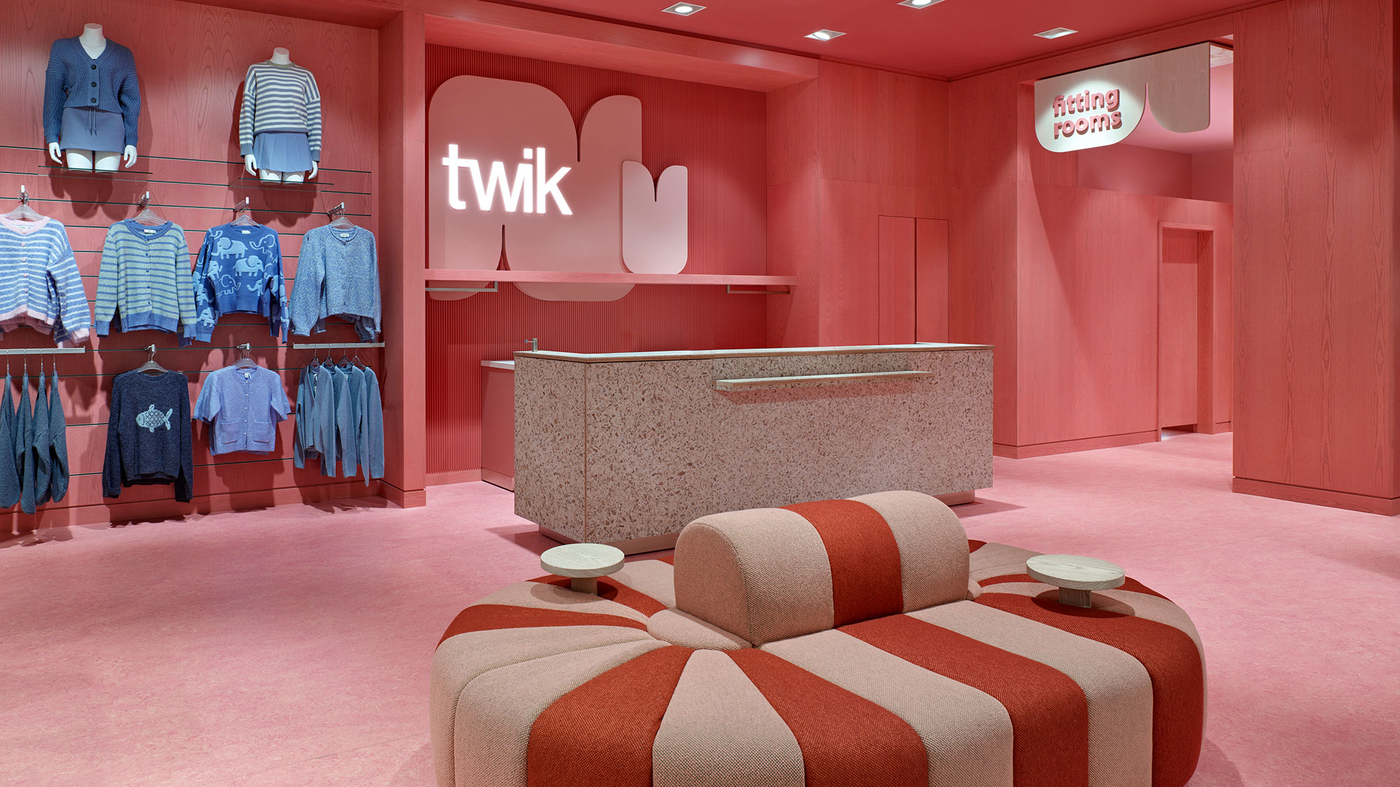 A room with a couch and a table with a chair in it.