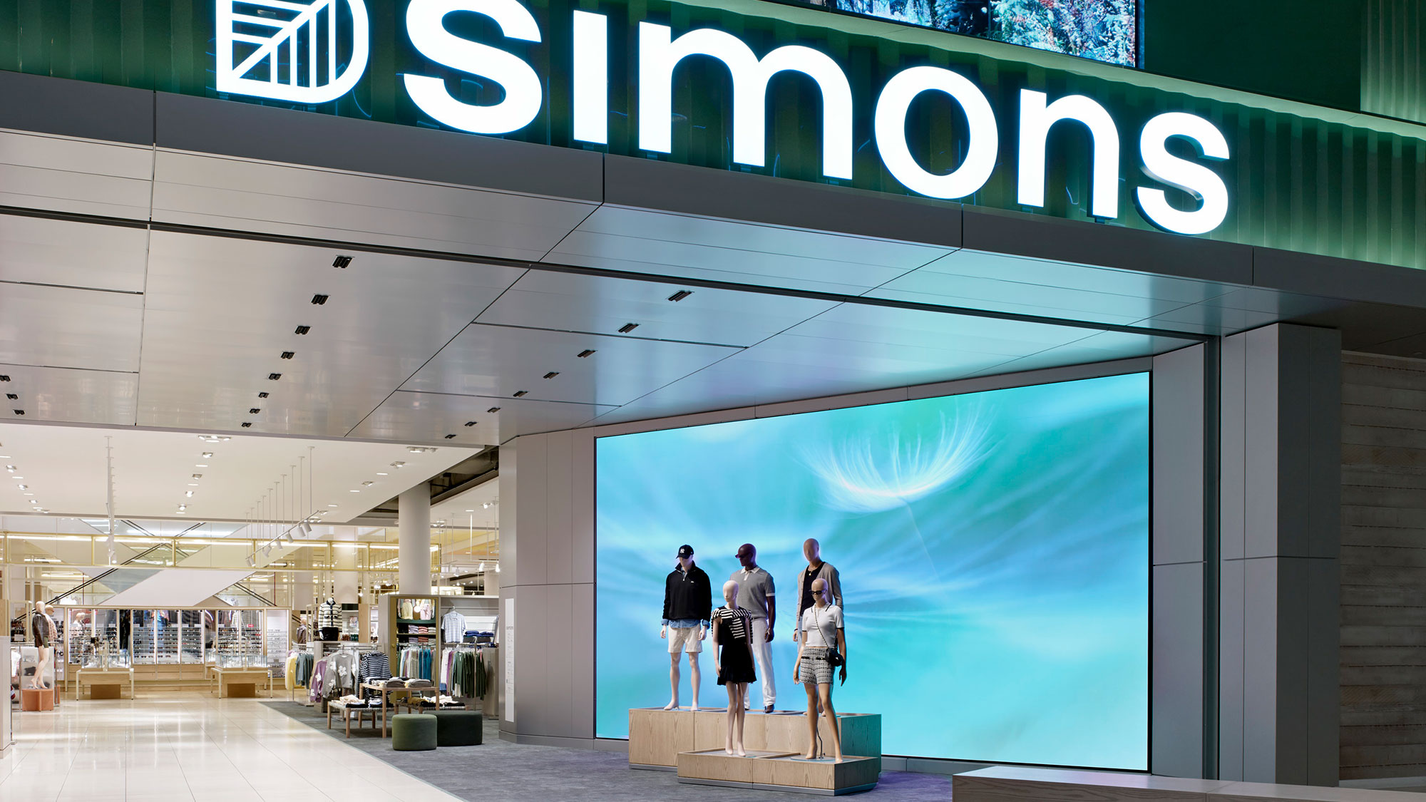 People standing in front of a large screen.