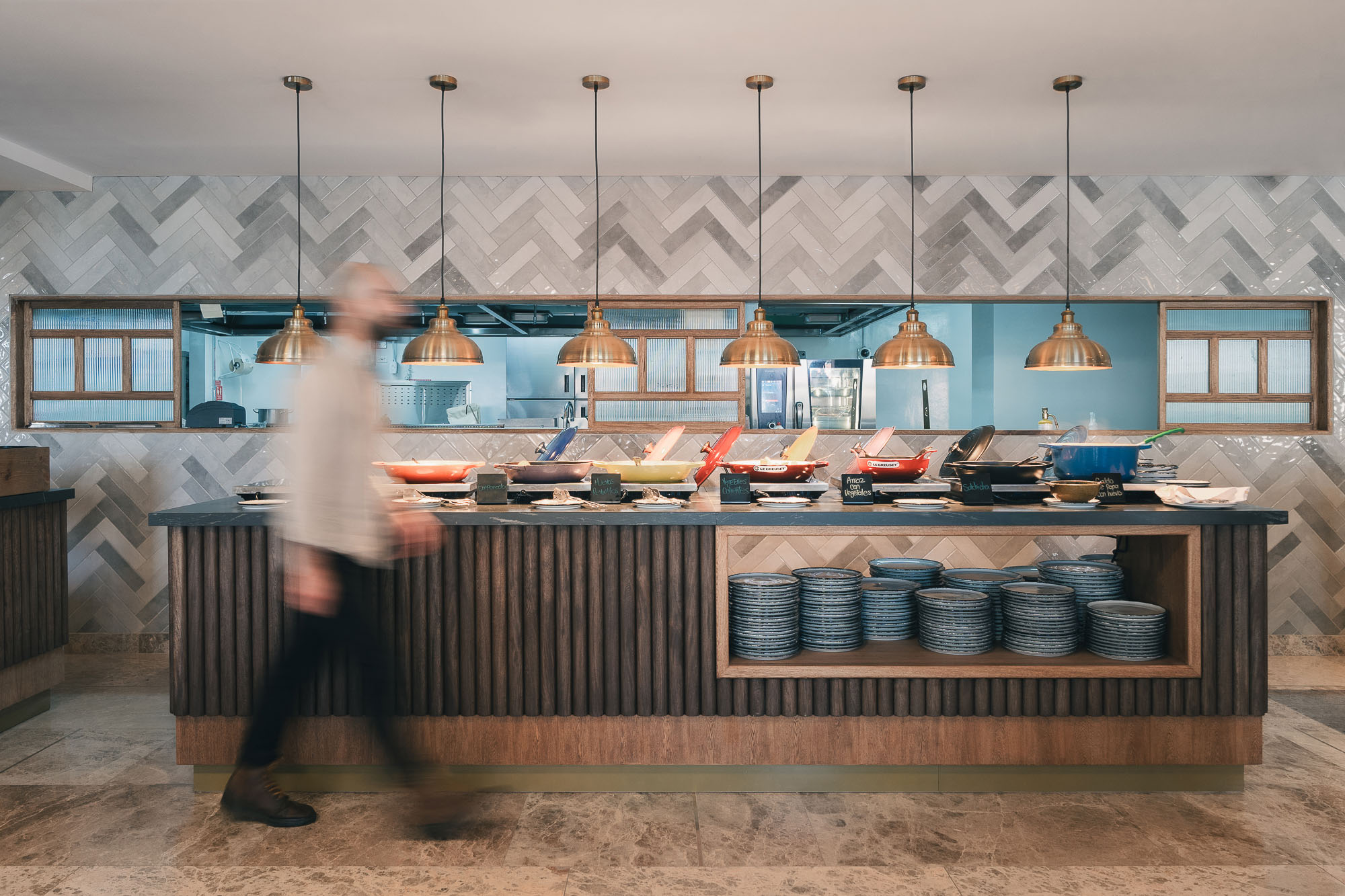 A person standing next to a table with food on it.
