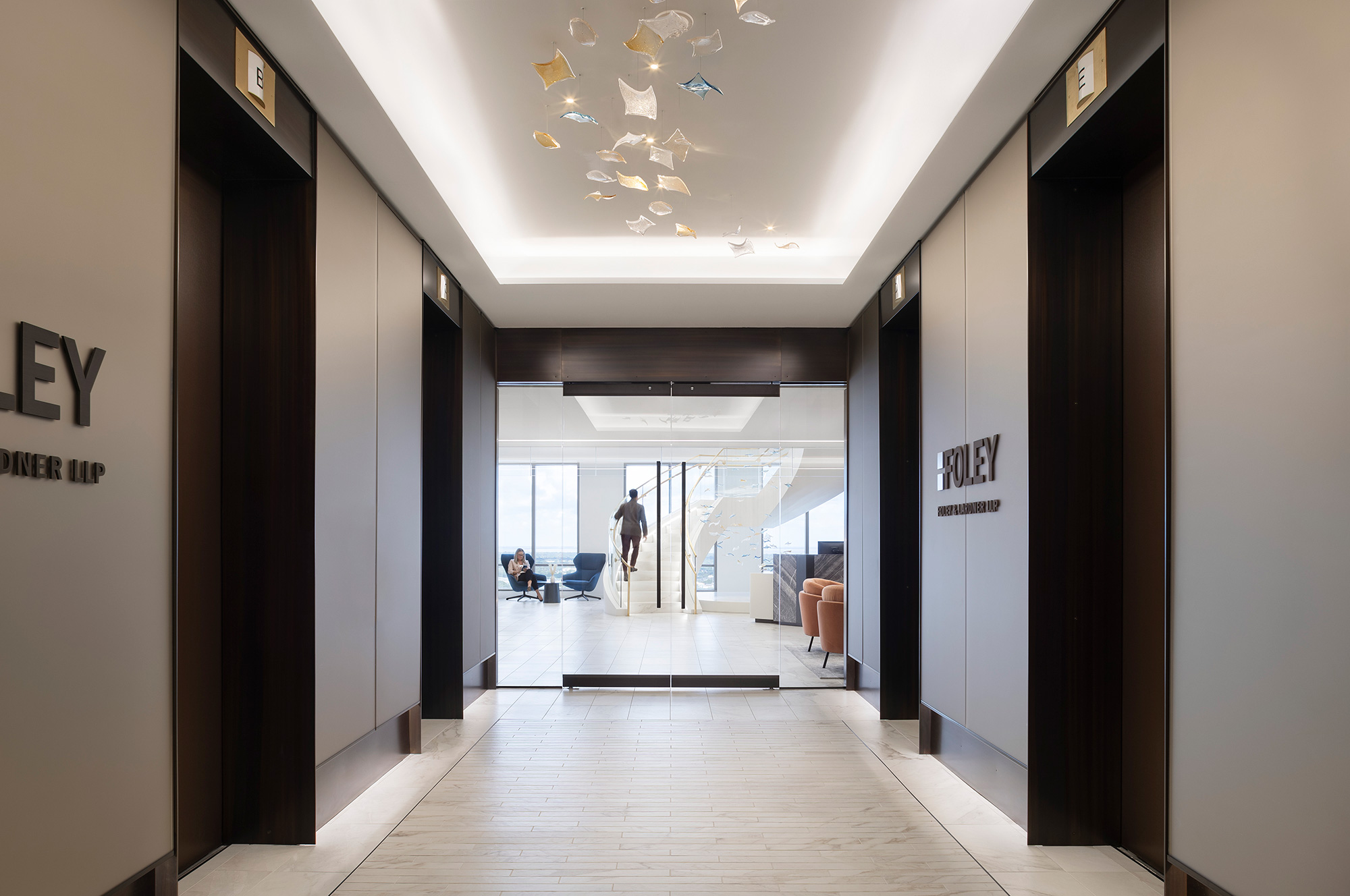 A long hallway with a person walking.