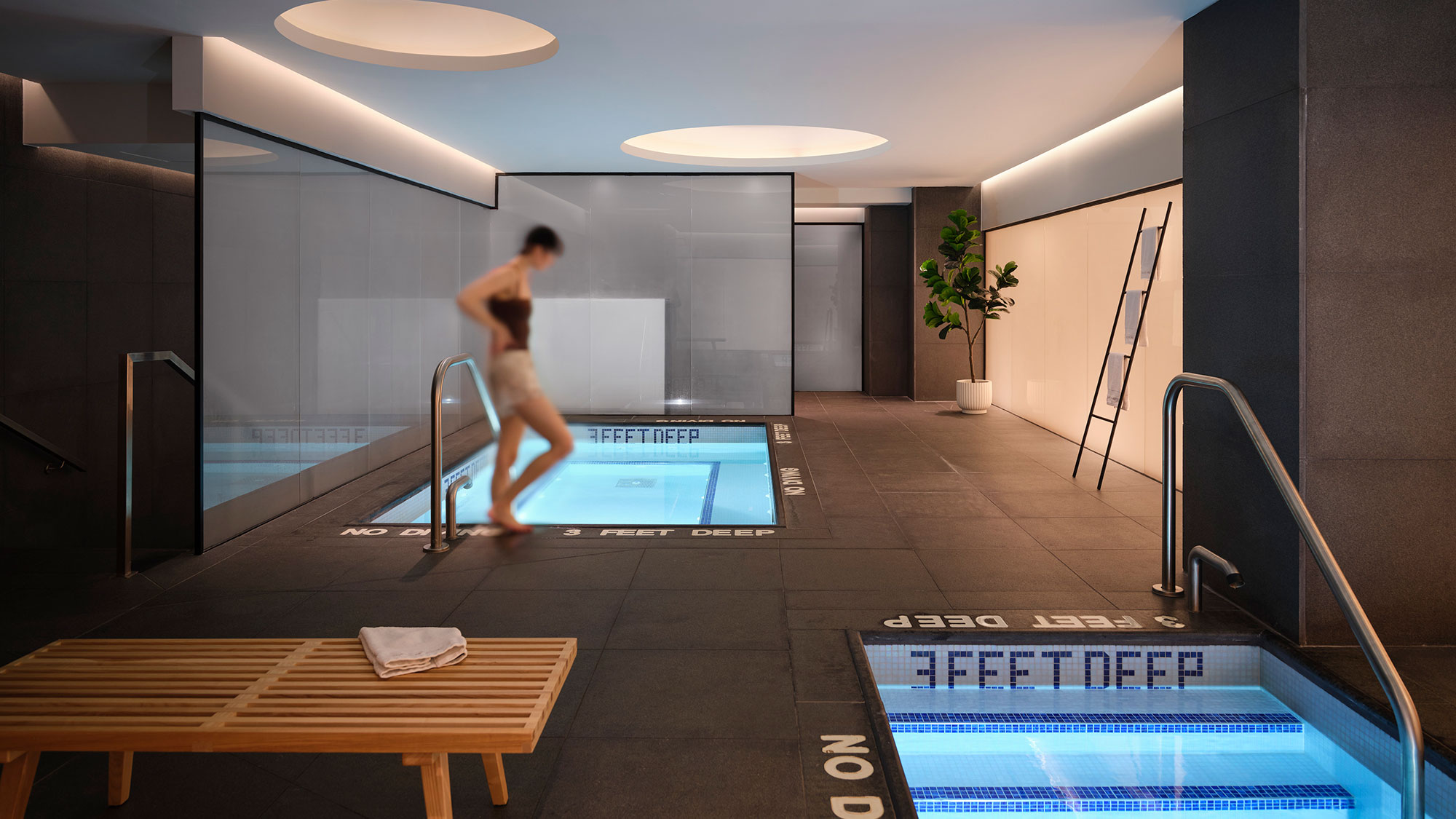 A person jumping into a swimming pool.