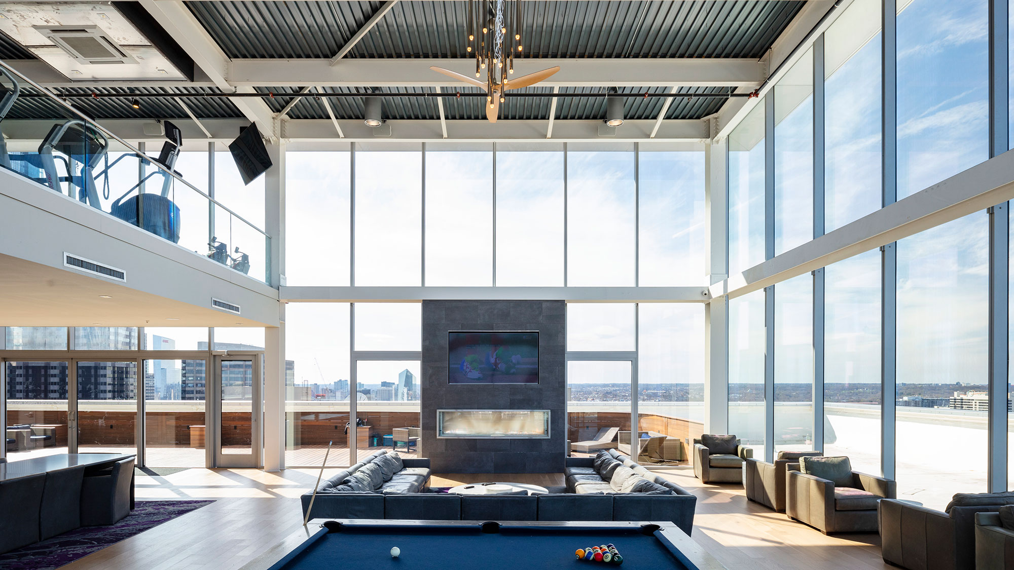 A room with a fireplace and large windows.