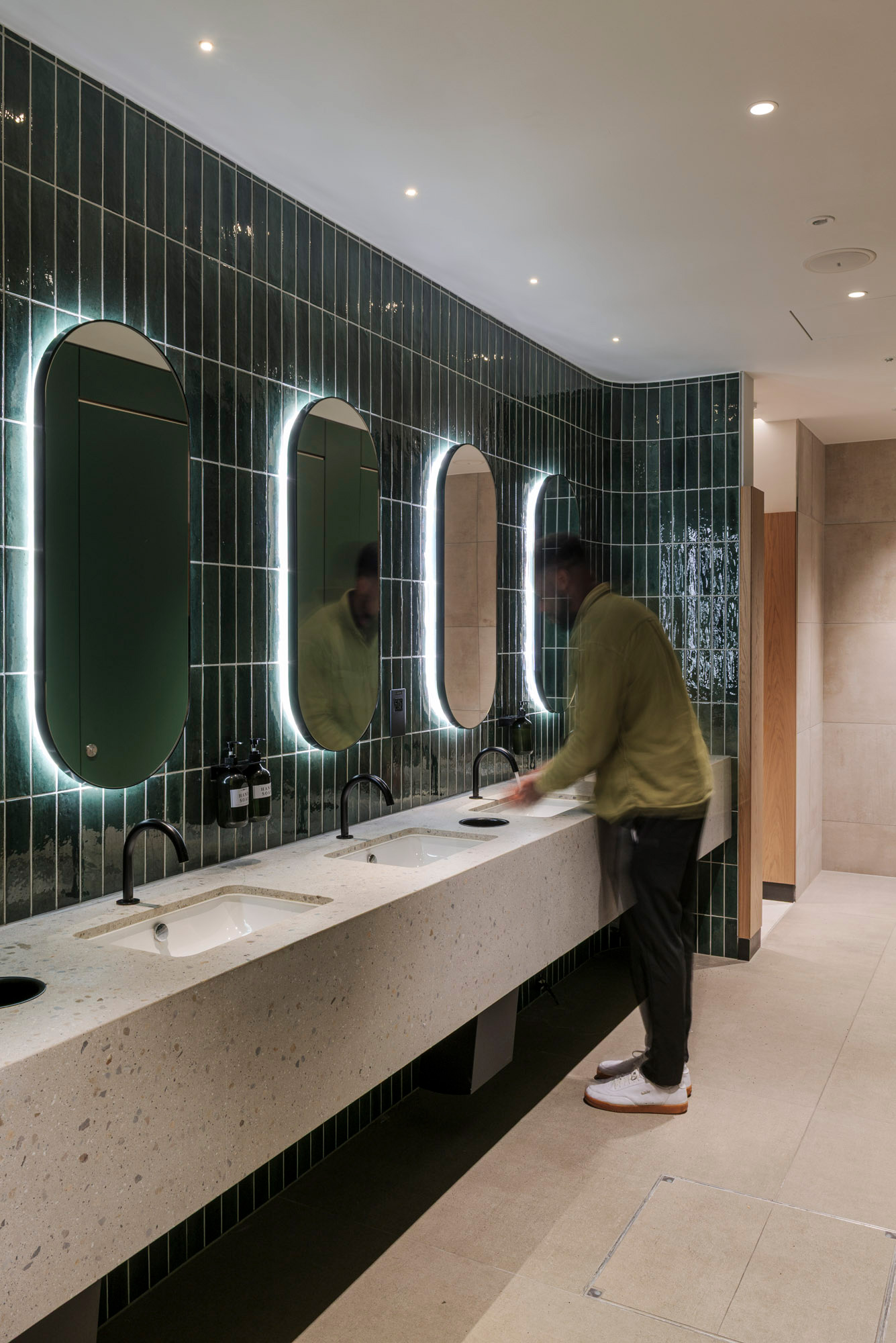 A man standing in a bathroom.