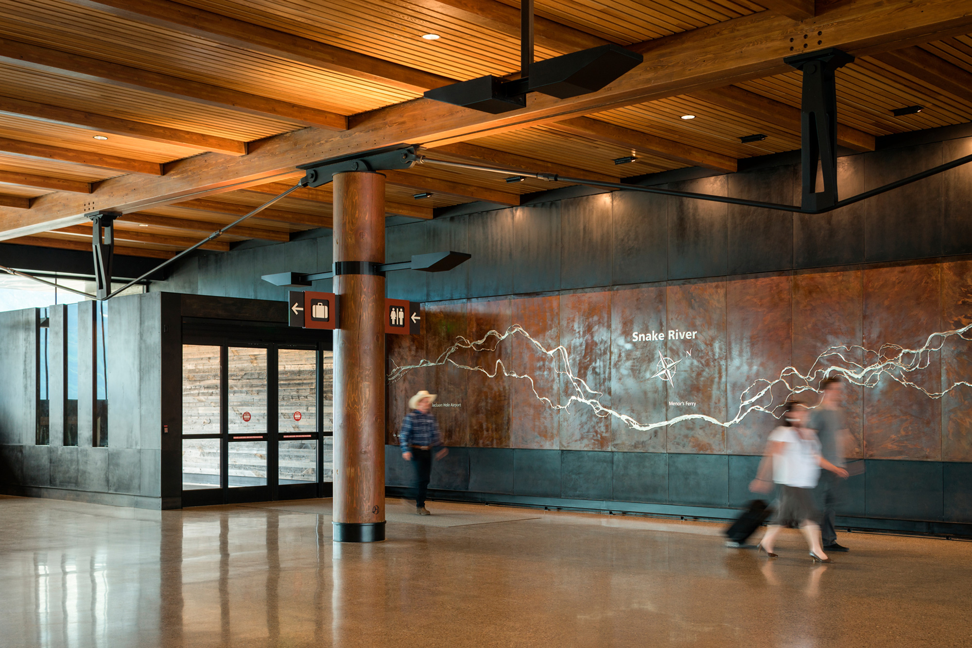 A group of people walking in a building with graffiti on the walls.