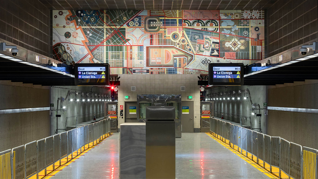 A subway station with a large sign.