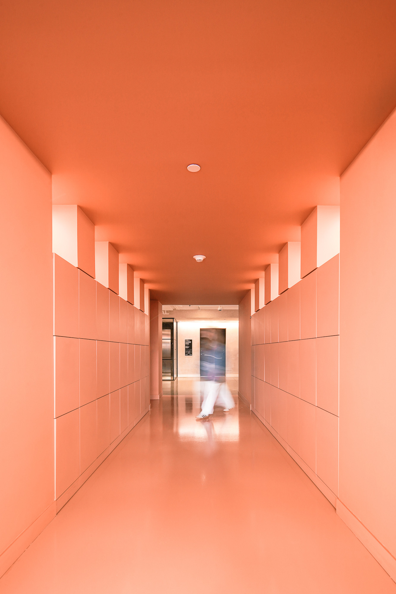 A person walking through a hallway.