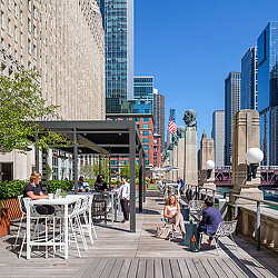 People sitting at tables outside.