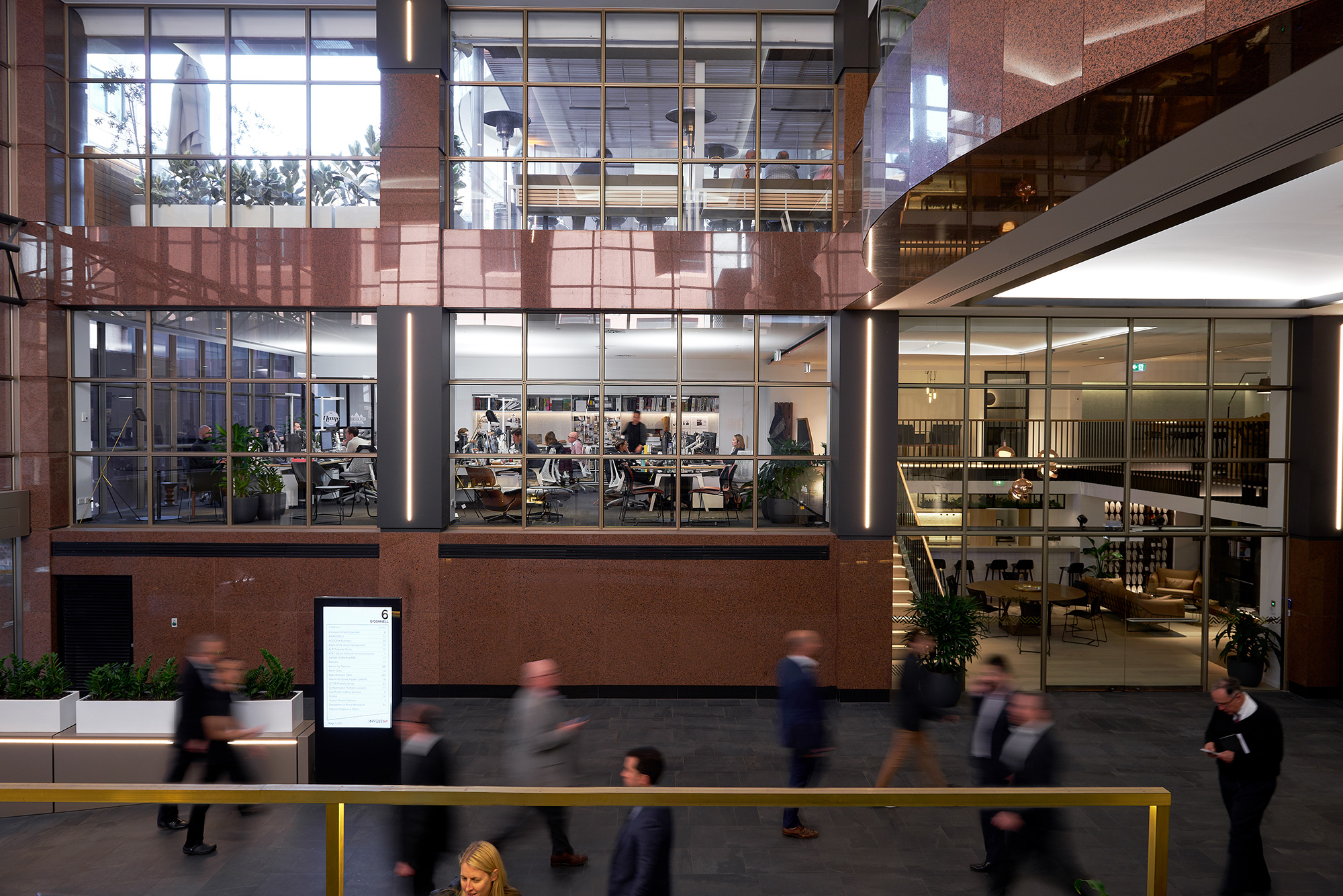 A group of people walking in a building.