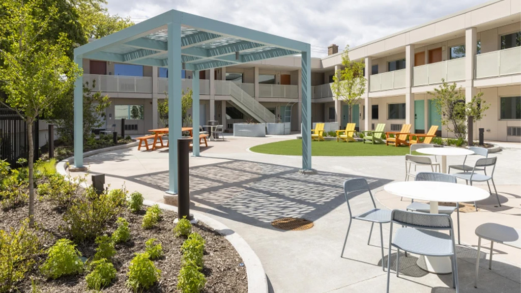 A patio with tables and chairs.