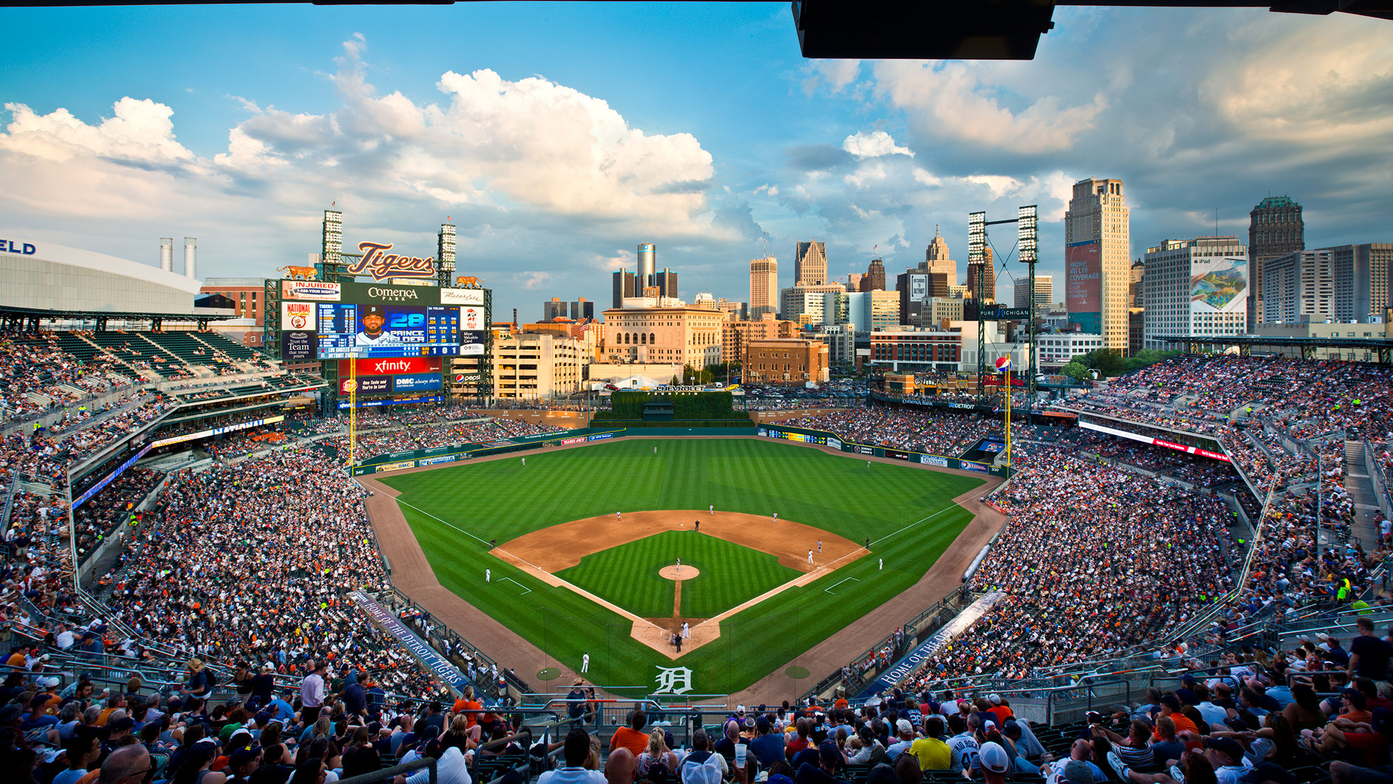 A baseball stadium with a large crowd.